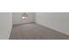 Vacant bedroom featuring neutral carpet, white walls, baseboards, and a bright window at 42510 W Peters Dr, Maricopa, AZ 85138