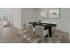 Elegant dining room featuring a large black table and seating for six at 42510 W Peters Dr, Maricopa, AZ 85138