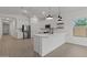 Spacious kitchen with an island, stainless steel appliances, and white cabinets at 42510 W Peters Dr, Maricopa, AZ 85138