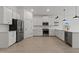 Bright kitchen featuring stainless steel appliances, white cabinetry, and a tiled backsplash at 42510 W Peters Dr, Maricopa, AZ 85138