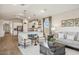 Open-concept living space with kitchen island, comfortable seating, and stylish decor at 42510 W Peters Dr, Maricopa, AZ 85138