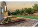 An additional view of the backyard with mature trees and manicured lawn at 4326 E Cloudburst Ct, Gilbert, AZ 85297