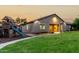 Backyard featuring green lawn, covered patio, and charming playset for Gathering fun and outdoor entertainment at 4326 E Cloudburst Ct, Gilbert, AZ 85297