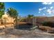 Spacious backyard features a trampoline, stone patio, and block fence, offering privacy and fun at 4326 E Cloudburst Ct, Gilbert, AZ 85297