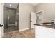 Neutral bathroom with glass shower, wood-look flooring, and bright vanity at 4326 E Cloudburst Ct, Gilbert, AZ 85297