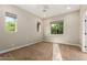 Neutral bedroom with three windows, ceiling fan, and carpet at 4326 E Cloudburst Ct, Gilbert, AZ 85297