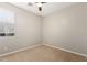 Bedroom features neutral walls, a ceiling fan, and plush carpet at 4326 E Cloudburst Ct, Gilbert, AZ 85297