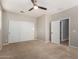 Spacious bedroom with double closets, ceiling fan, and neutral carpet at 4326 E Cloudburst Ct, Gilbert, AZ 85297
