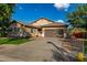 Lovely single-story house with a well-kept lawn, desert landscaping, and a two-car garage at 4326 E Cloudburst Ct, Gilbert, AZ 85297
