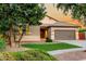 Inviting single-story home with a two-car garage, desert landscaping, and green lawn at 4326 E Cloudburst Ct, Gilbert, AZ 85297