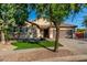 Single-story house with desert landscaping, lush green lawn and a convenient two-car garage at 4326 E Cloudburst Ct, Gilbert, AZ 85297