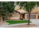 Well-maintained home boasts a tile roof, desert landscaping, and a two-car garage at 4326 E Cloudburst Ct, Gilbert, AZ 85297