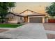 Charming single-story home featuring a neutral color palette, tile roof, and a well-manicured front lawn at 4326 E Cloudburst Ct, Gilbert, AZ 85297