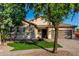 Single-story house with desert landscaping, lush green lawn and a convenient two-car garage at 4326 E Cloudburst Ct, Gilbert, AZ 85297