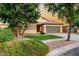 Inviting single-story home with a two-car garage, desert landscaping, and green lawn at 4326 E Cloudburst Ct, Gilbert, AZ 85297