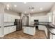 Modern kitchen with white cabinets, stainless appliances, island, and ample counter space at 4326 E Cloudburst Ct, Gilbert, AZ 85297