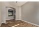 Living room featuring wood-look flooring, neutral paint, arched entry and plentiful natural light at 4326 E Cloudburst Ct, Gilbert, AZ 85297