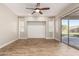 Open floor plan with stylish plank flooring, shiplap wall accent, and sliding glass doors at 4326 E Cloudburst Ct, Gilbert, AZ 85297