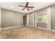 Bright living room features wood-look floors, neutral walls, ceiling fan, and natural light at 4326 E Cloudburst Ct, Gilbert, AZ 85297