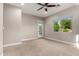 Main bedroom features neutral paint, carpet flooring, ceiling fan, recessed lighting and outdoor view at 4326 E Cloudburst Ct, Gilbert, AZ 85297