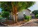 The well manicured yard features lovely landscaping with trees and decorative rock, offering a tranquil setting at 4326 E Cloudburst Ct, Gilbert, AZ 85297