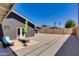 Low maintenance backyard with shade trees, lounge chairs, and gravel at 4435 N 35Th St, Phoenix, AZ 85018
