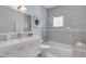 Updated bathroom features tiled shower over tub, modern vanity, and neutral paint at 4435 N 35Th St, Phoenix, AZ 85018