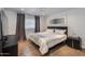 Serene bedroom featuring a large bed, dark wood flooring, neutral tones, and contemporary decor at 4435 N 35Th St, Phoenix, AZ 85018