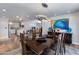 Open-concept dining room with stylish lighting, modern art, and seamless flow into the adjacent kitchen and living areas at 4435 N 35Th St, Phoenix, AZ 85018