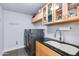 Laundry room with front loading washer and dryer, granite countertops and storage at 4435 N 35Th St, Phoenix, AZ 85018