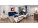 Comfortable living area with a blue velvet couch, sleek furniture, and bright natural light from the doors at 4435 N 35Th St, Phoenix, AZ 85018