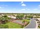 Aerial view of tennis court, neighborhood homes, and lush greenery at 4615 W Del Rio St, Chandler, AZ 85226