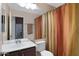 Cozy bathroom featuring vanity, toilet, and shower with colorful curtain at 4615 W Del Rio St, Chandler, AZ 85226