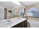 Bathroom featuring dual sinks, a glass-enclosed shower, and a soaking tub at 4615 W Del Rio St, Chandler, AZ 85226