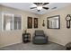 Comfortable bedroom with chair, ceiling fan, and window with blind at 4615 W Del Rio St, Chandler, AZ 85226