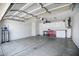 Spacious garage featuring ample lighting, storage cabinets, and a clean epoxy floor at 4615 W Del Rio St, Chandler, AZ 85226