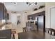 Modern eat-in kitchen featuring stainless steel appliances, granite countertops, and dark wood cabinets at 4615 W Del Rio St, Chandler, AZ 85226