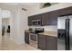 Modern kitchen featuring stainless steel appliances, ample counter space, and dark wood cabinets at 4615 W Del Rio St, Chandler, AZ 85226