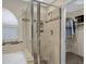 Glass shower featuring shower head, built in shelves and tiled backsplash at 4615 W Del Rio St, Chandler, AZ 85226