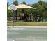Community basketball court and playground area with swings, a jungle gym, and a shade cover at 4626 E Summerhaven Dr, Phoenix, AZ 85044