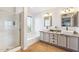 Bright bathroom featuring double sinks, granite countertops, a bathtub, and a glass-enclosed shower at 4626 E Summerhaven Dr, Phoenix, AZ 85044