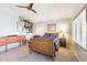 Cozy bedroom includes warm lighting, carpet, and a comfortable bed. Nice ceiling fan at 4626 E Summerhaven Dr, Phoenix, AZ 85044