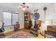 Inviting bedroom featuring a ceiling fan, hardwood floors, and a cozy reading nook at 4626 E Summerhaven Dr, Phoenix, AZ 85044