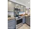 Close-up of kitchen features stainless steel oven and microwave with granite countertops and tile backsplash at 4626 E Summerhaven Dr, Phoenix, AZ 85044