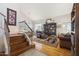 Comfortable living area showcasing hardwood floors, a cozy reading chair, and elegant decor at 4626 E Summerhaven Dr, Phoenix, AZ 85044