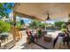 Relaxing covered patio with comfortable seating, lush greenery, and view of the backyard pool at 4626 E Summerhaven Dr, Phoenix, AZ 85044
