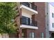 Brick condo building featuring private balconies with black railings and modern design at 475 N 9Th St # 206, Phoenix, AZ 85006