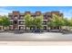 Modern townhome exterior with brick facade, balconies, and well-maintained landscaping at 475 N 9Th St # 206, Phoenix, AZ 85006