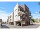 Modern condo building with brick and white accents, featuring balconies and covered parking at 475 N 9Th St # 206, Phoenix, AZ 85006
