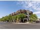 Beautiful exterior shot of a brick condominium building on a sunny day with a clear blue sky at 475 N 9Th St # 206, Phoenix, AZ 85006